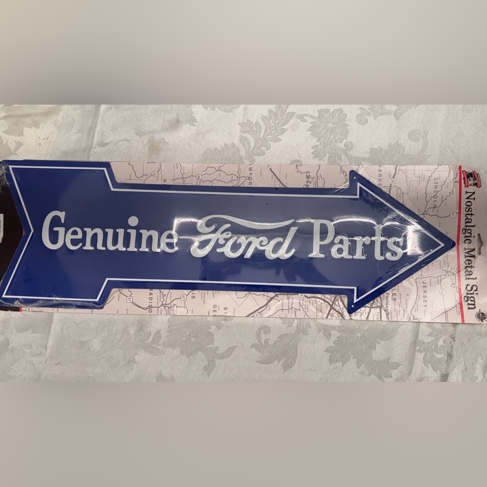 Ford Blue Arrow Sign with White Text “Genuine Ford Parts”
